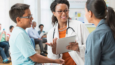 Doctor talking to mother and son in a hospital.