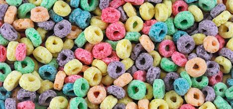 A colorful assortment of cereal pieces in various shapes, featuring bright hues like red, yellow, green, and purple.