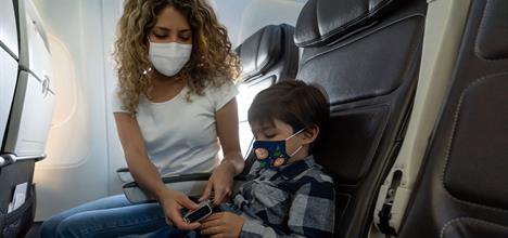 child on airplane wear face mask for COVID