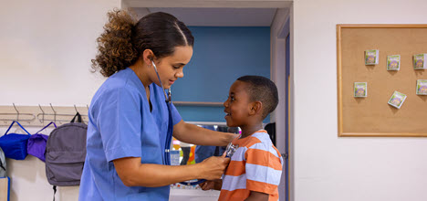 school nurse examining boy