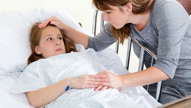 mom sick daughter in hospital bed